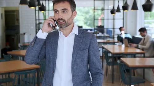 Businessman using smartphone in cafe