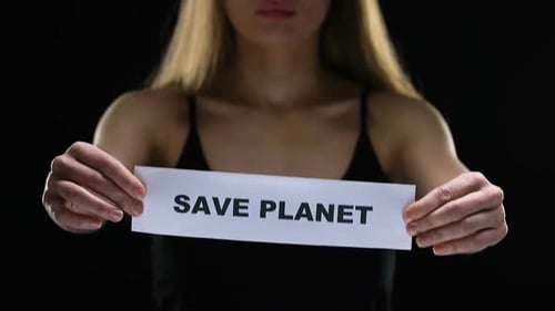 Young Woman Holding Save Planet Sign