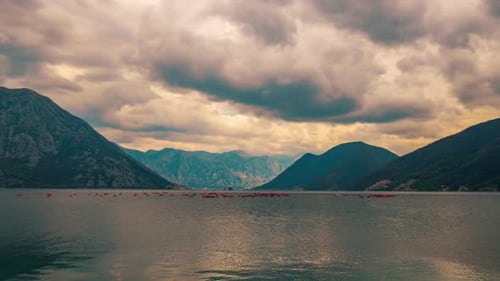 Scenic Bay Surrounded by Mountains at Sunset