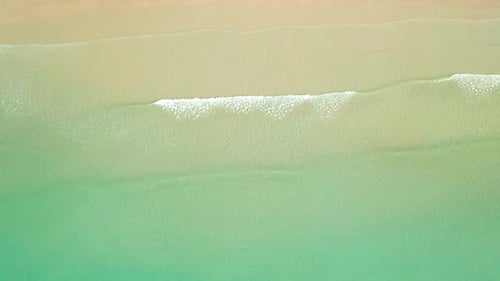 4K Aerial view top view of drone, sea waves and beautiful sand beach.