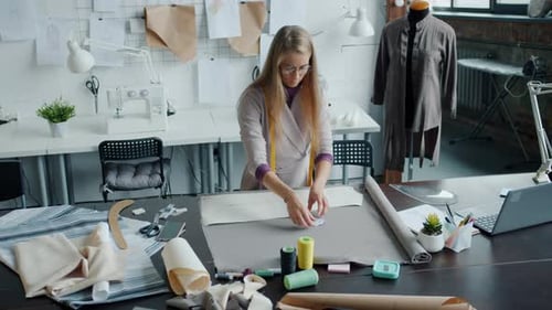 Slow Motion Portrait of Professional Seamstress Creating New Fashionable Garment in Studio