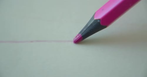 Pink Pencil Drawing a Line on White Paper