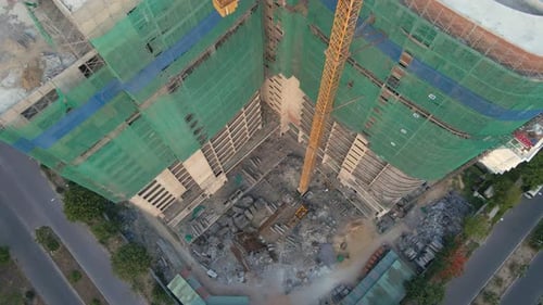 Aerial Shot of the Construction Site with One Onstruction Crane. Tall Building Construction Concept