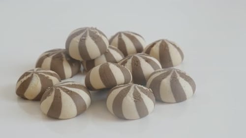 Tasty bicolor biscuits close-up 4K 2160p 30fps UltraHD tilting footage - Pile of cookies with milk