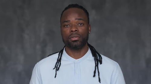 Man Looking at Camera with Braids in Studio