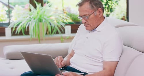 Man Using Laptop Computer in Living Room