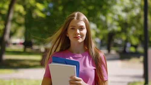 Student in Park with Books in Hands