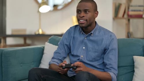 Young Adult Relaxing at Home Playing Video Games