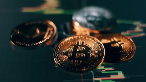 Close Up of Crypto Coins on Line Graph