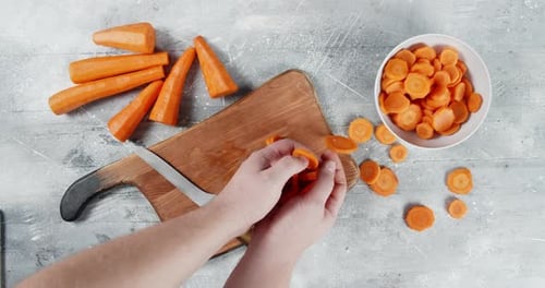 Fresh Carrots Being Sliced in a Bright Kitchen