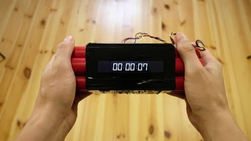 Hands Hold Sticks with Digital Countdown Clock