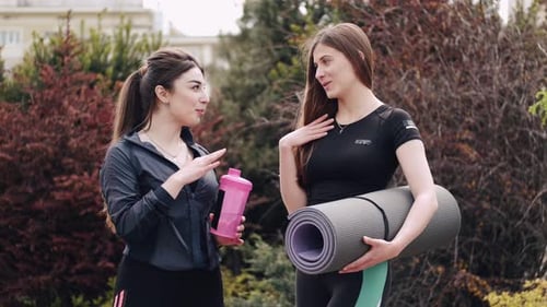 Two Women Chatting Before Yoga in the Park