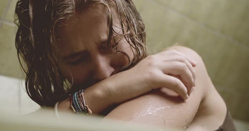 Sad Young Woman Resting with Damp Hair