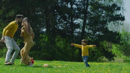 Happy Family Playing Together in a Spring Park