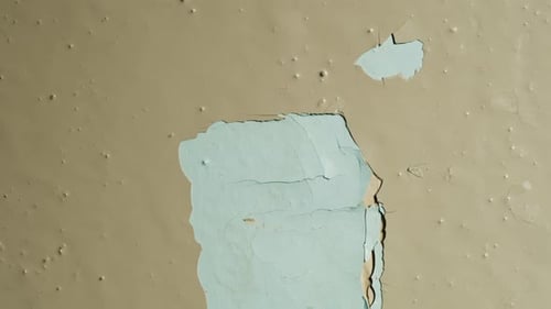 Peeling Light Blue Paint on Wall Close Up