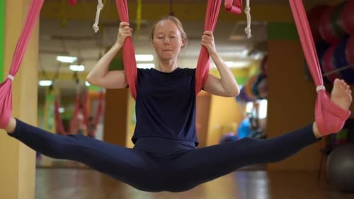 Woman Aerial Yoga Pose in Urban Gym
