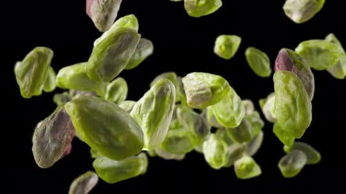 Shelled Pistachios Floating on Black Background