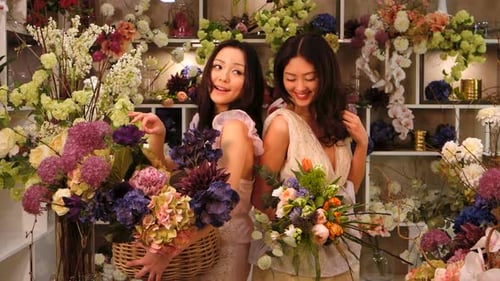 Florists. Asian Women Happy Working in Flower Store