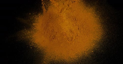 Turmeric, curcuma longa, Powder Exploding against Black Background, Indian Spice, Slow Motion 4K
