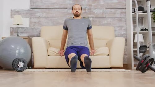 Man Exercising at Home, Doing Dips on Couch