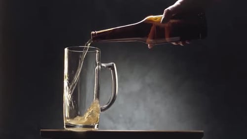 Golden Beer Pouring into Glass Mug
