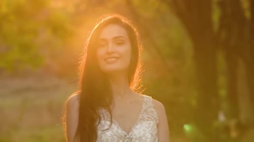 Beautiful Brunette Bride Is Posing in Sunny Rays at Sunset. Autumn Nature. Slow Motion