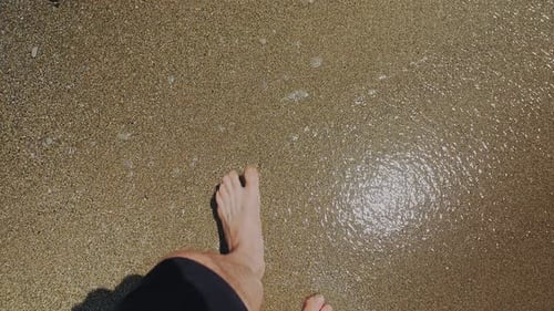 Barefoot Guy Walks Along Wet Beach