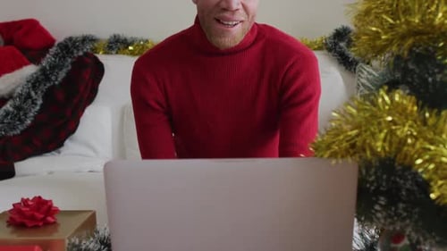 Man in Santa Hat Video Chatting at Christmas