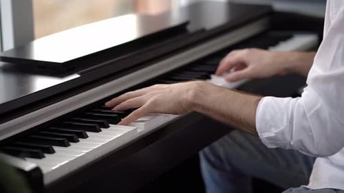 Close Up of Hands Playing Piano