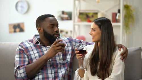 Young Couple Clinking Wine Glasses, Romantic Evening at Home, Togetherness