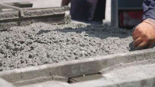 Concrete Worker Smoothing Cement with Trowel