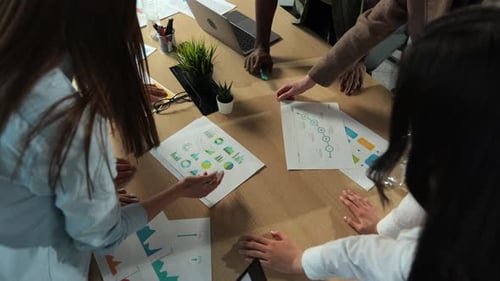 Diverse Team Collaborating on Data Analysis in Bright Office