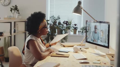 Une femme d'affaires noire parle avec un collègue lors d'un appel Web sur un ordinateur
