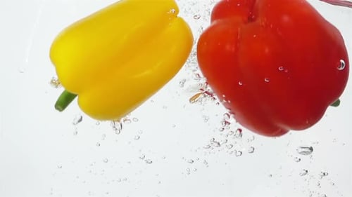 Vibrant Peppers Plunge Into Refreshing Water
