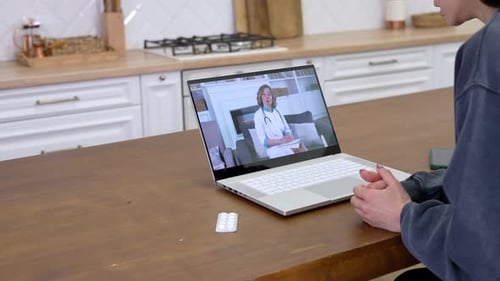 Woman Telemedicine Call with Doctor on Laptop