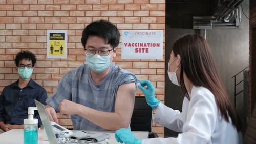Asians people queue for prevention coronavirus (COVID-19) vaccinations.