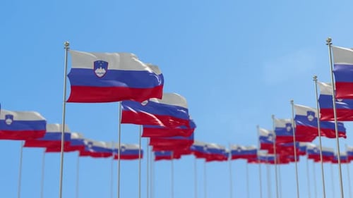 Multiple Slovenia Flags Waving in the Wind under Blue Sky