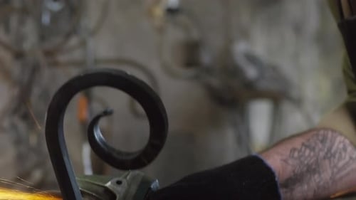 Craftsman Using Hand Sander in Smithy