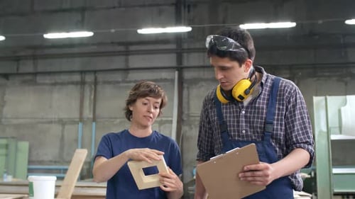 Man and Woman Walking along Workshop