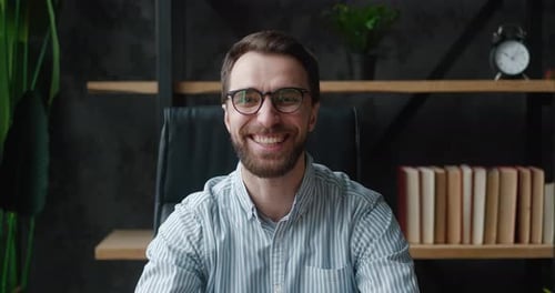 Man Smiling and Laughing in an Indoor Setting