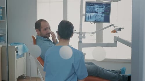 Dentist Consults with Patient About X-Ray Results