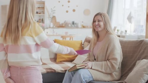 Girl Giving Mother Birthday Card in Home