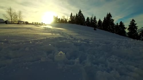 Footsteps in the Cold Snow Near Small Village