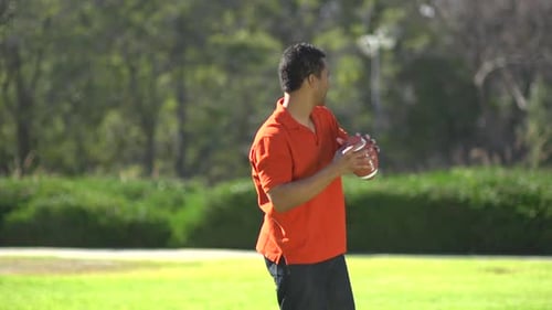 Dad and Son Playing Football in Park
