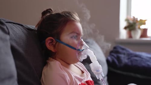 Young Child Uses Nebulizer at Home