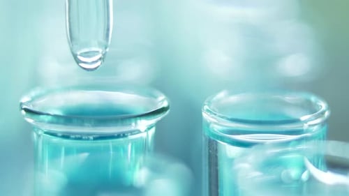 Clear Liquid Dropped into Laboratory Test Tube