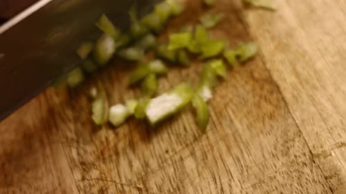 Close View Man's Hand Chopping Green Fresh Pepper with Sharp Knife