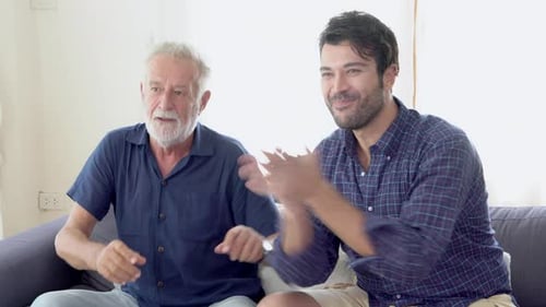 Men Watching Exciting Sports Game on the Couch