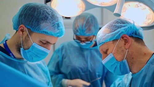 Medical Team Performing Operation in Bright Operating Room