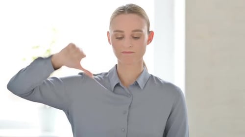 Young Woman Gives Thumbs Down Gesture